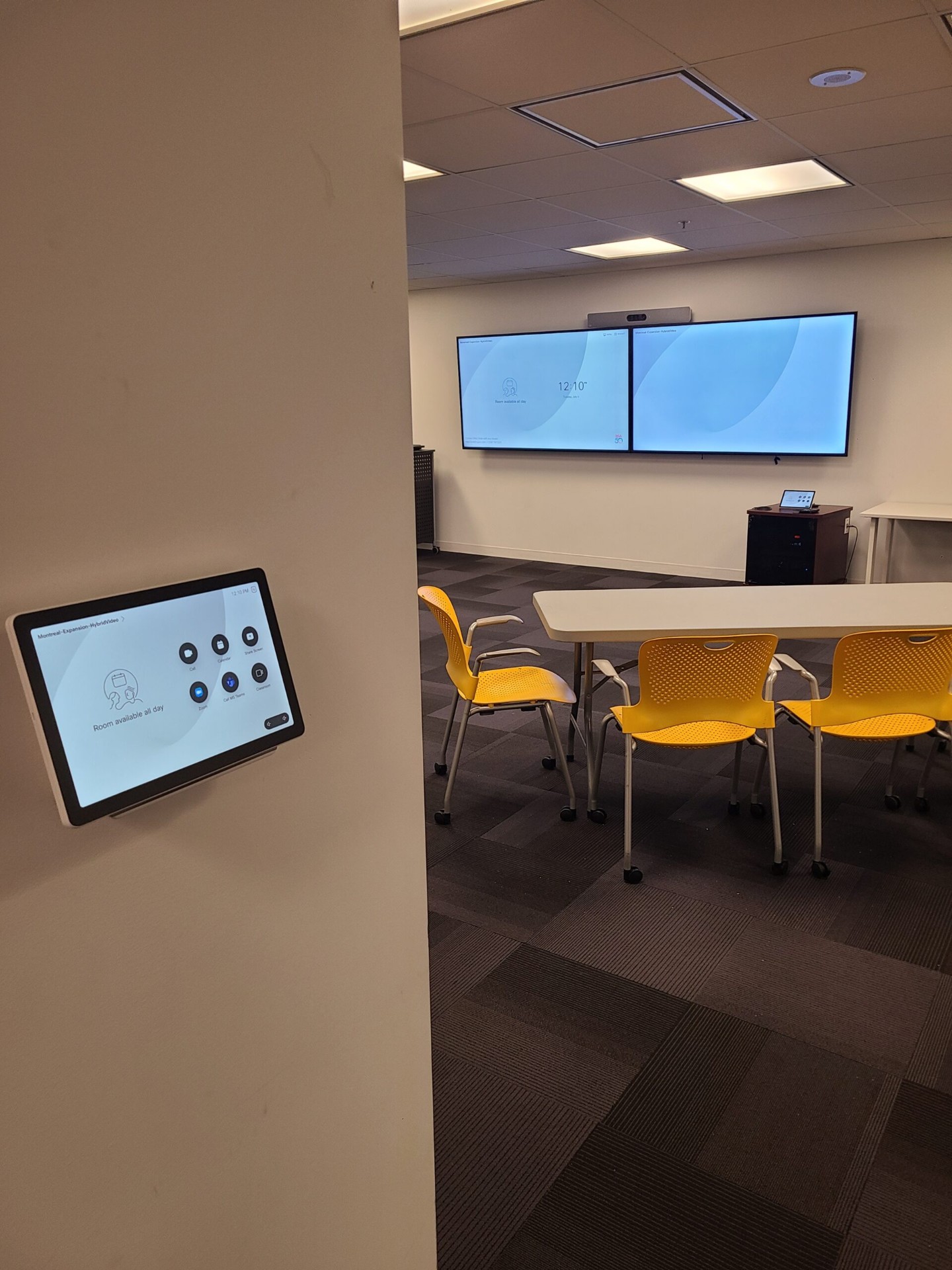 Cisco Webex Room Kit Plus conference room with dual displays and touch controller