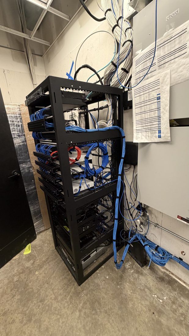 After: new full-size equipment rack with neatly routed network cabling
